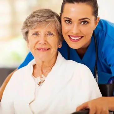 Caregiver smiling with an older woman